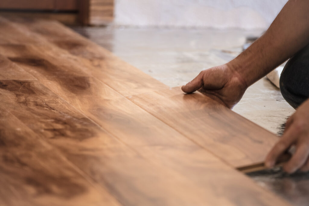 man installing hardwood floor